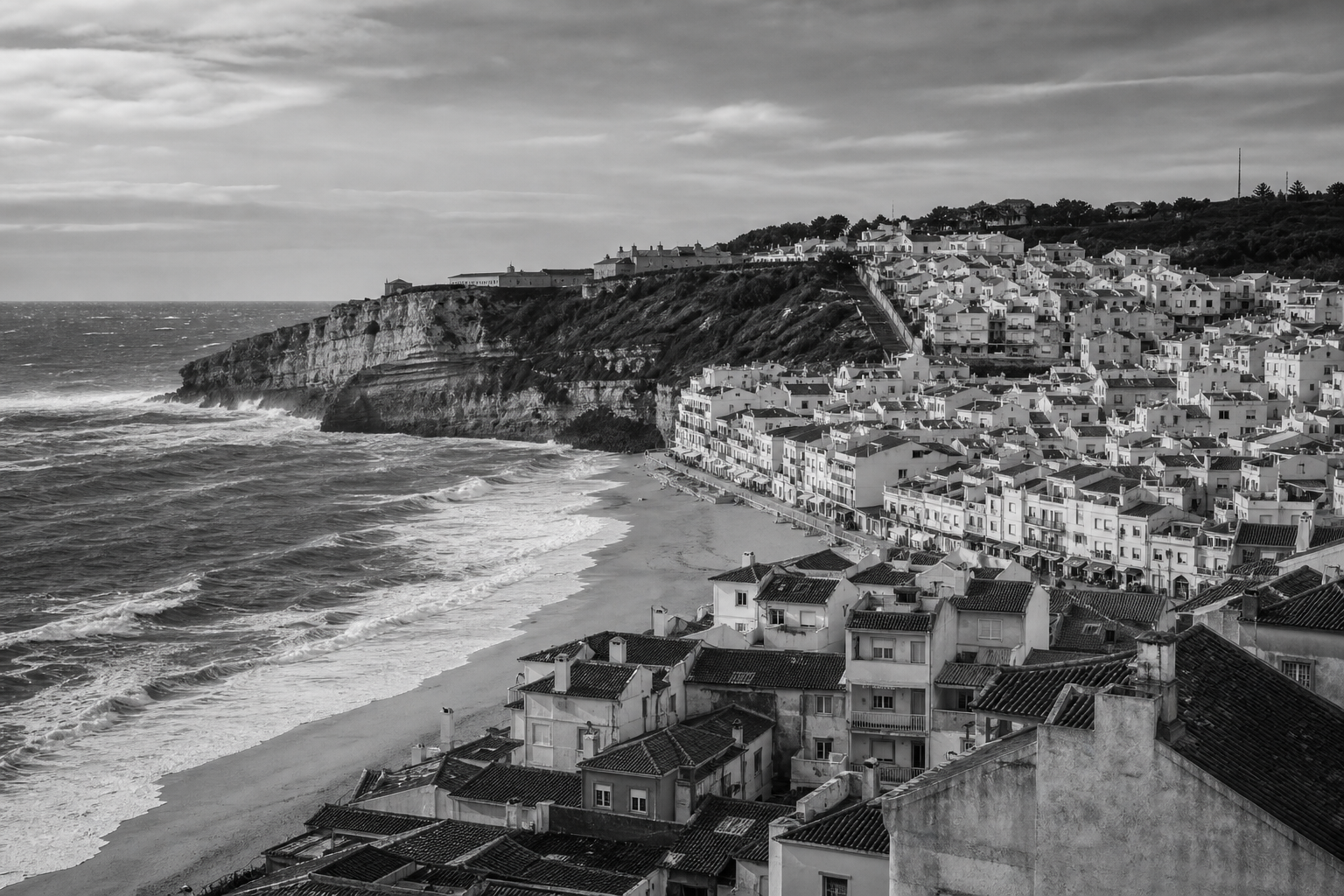 Black and white Nazare Portugal coastal cityscape for private investigator services in Nazare